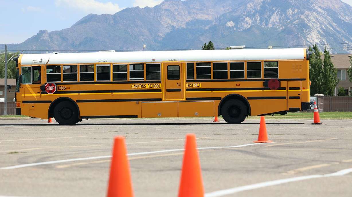 A student driver and instructor navigate a bus around cones in a parking lot at a Canyon School District building in Sandy on Monday, July 19, 2021. From bus drivers to school nutrition workers, districts are facing challenges filling critical support positions amid a post-pandemic labor shortage. Canyons School District is offering $21 to lure qualified employees.