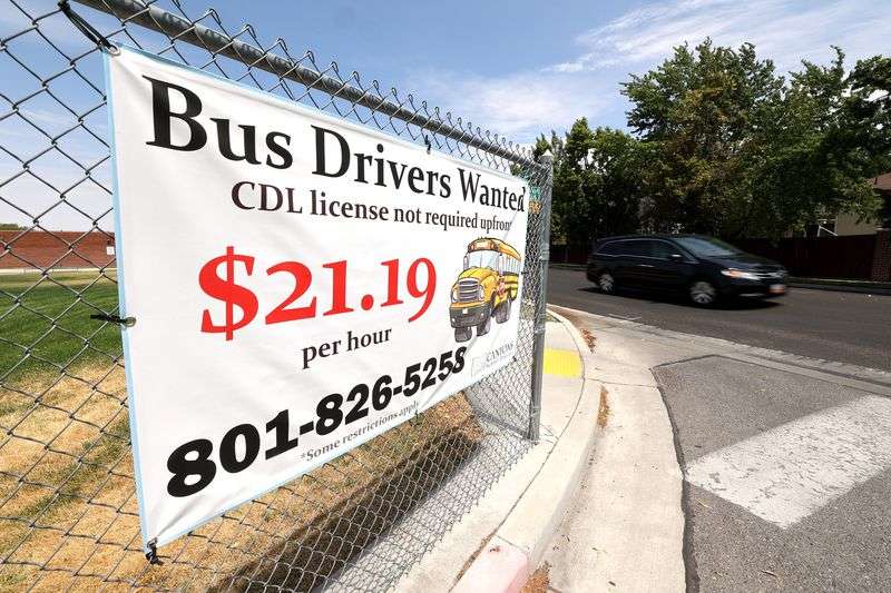 A "Bus Drivers Wanted” sign is pictured at a Canyon
School District building in Sandy on Monday, July 19, 2021. From
bus drivers to school nutrition workers, districts are facing
challenges filling critical support positions amid a post-pandemic
labor shortage. Canyons School District is offering $21 to lure
qualified employees.