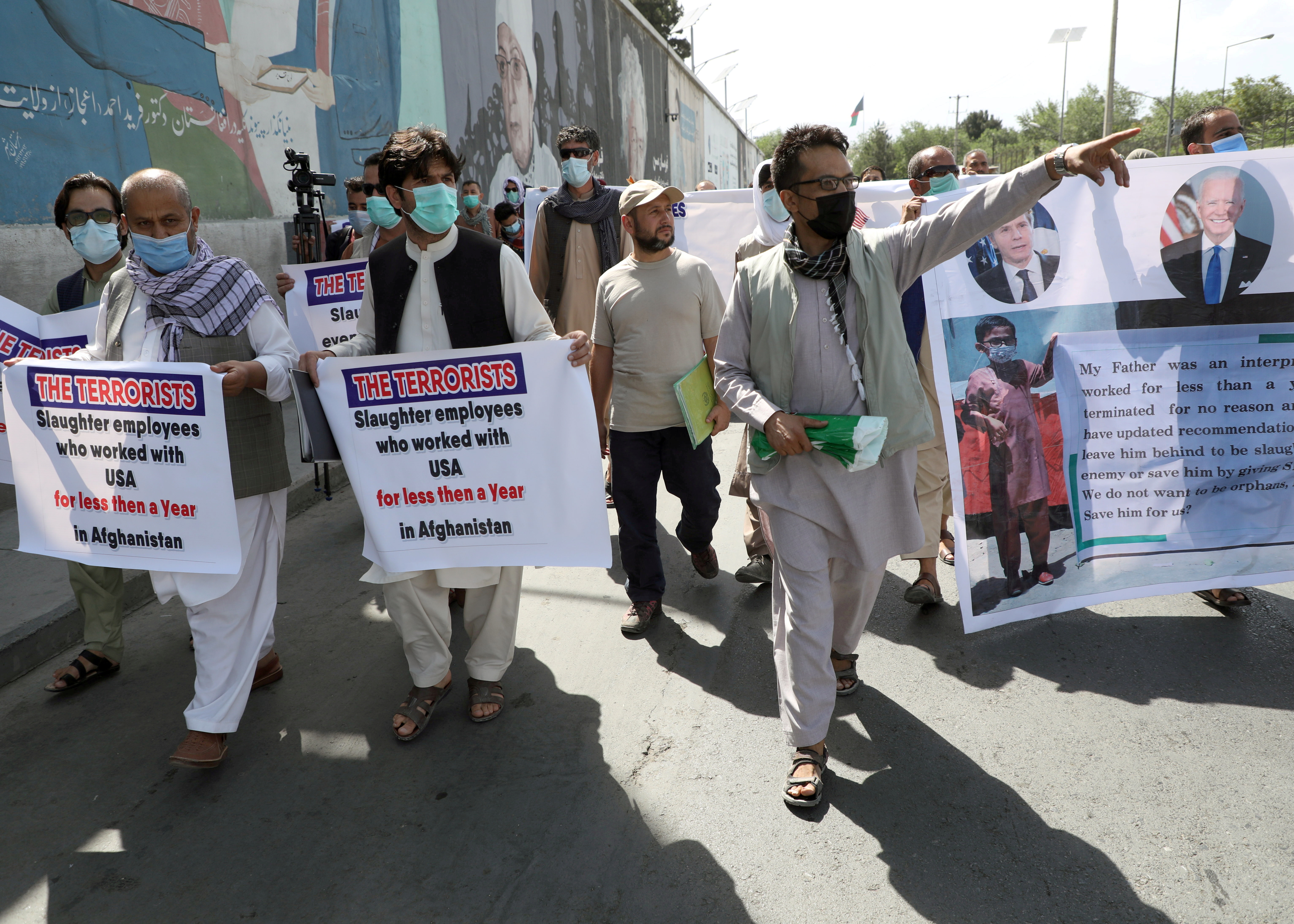 Former Afghan interpreters, who worked with U.S. troops in Afghanistan, demonstrate in front of the U.S. embassy in Kabul June 25, 2021. Thousands more Afghans who may be targets of Taliban violence due to their U.S. affiliations will have the opportunity to resettle as refugees in the United States.
