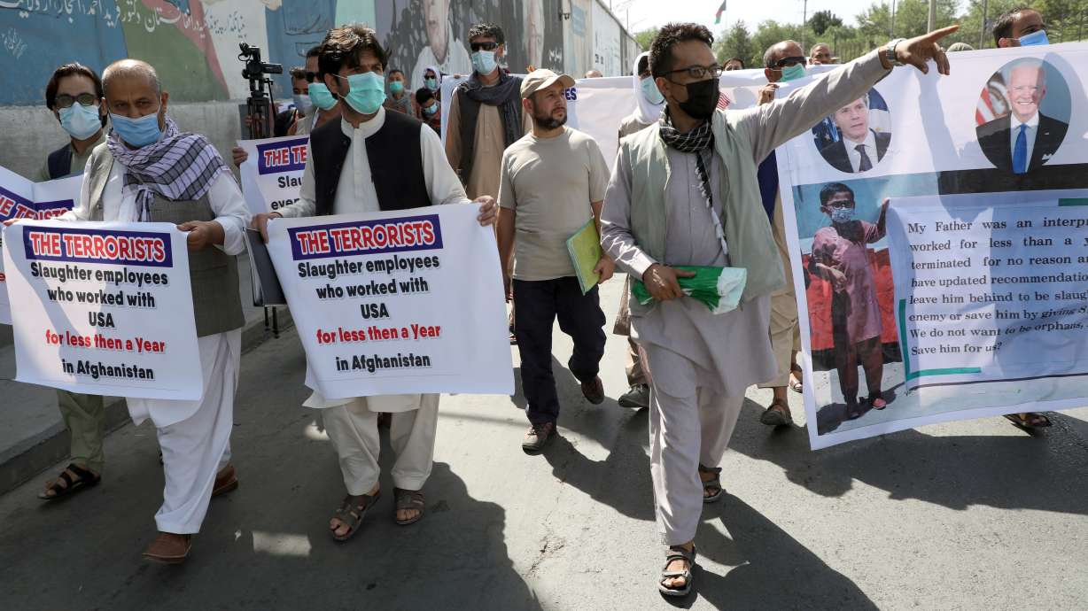 Former Afghan interpreters, who worked with U.S. troops in Afghanistan, demonstrate in front of the U.S. embassy in Kabul June 25, 2021. Thousands more Afghans who may be targets of Taliban violence due to their U.S. affiliations will have the opportunity to resettle as refugees in the United States.