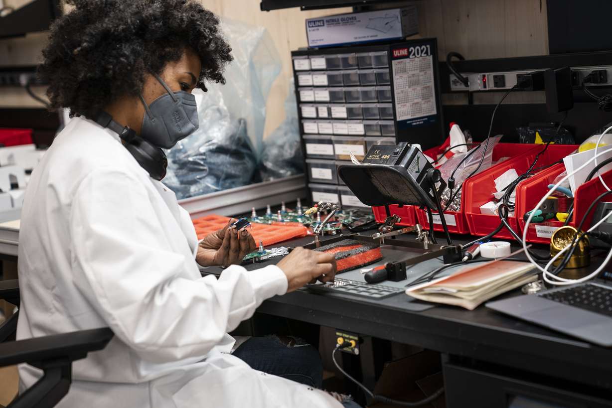 An employee manually assembles a circuit-board before a ribbon-cutting ceremony to mark the opening of a Nanotronics manufacturing center at the Brooklyn Navy Yard on Wednesday, April 28, 2021. Matthew Putman, CEO of Nanotronics, said he agonized over his decision to impose a vaccine mandate on his more than 100 employees, who have mostly been working onsite throughout the pandemic.