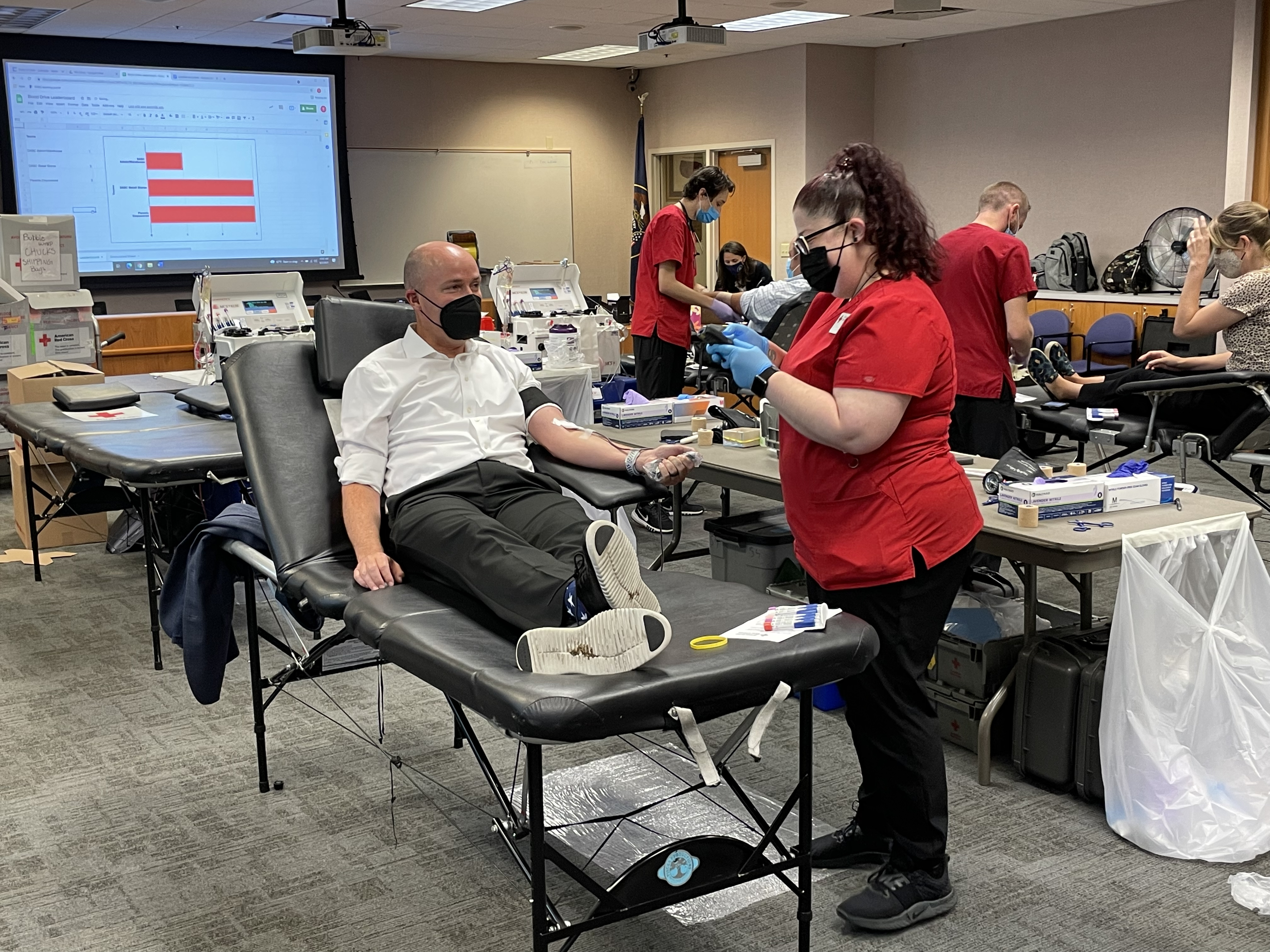 Utah Gov. Spencer Cox donates blood in Salt Lake City Monday.
