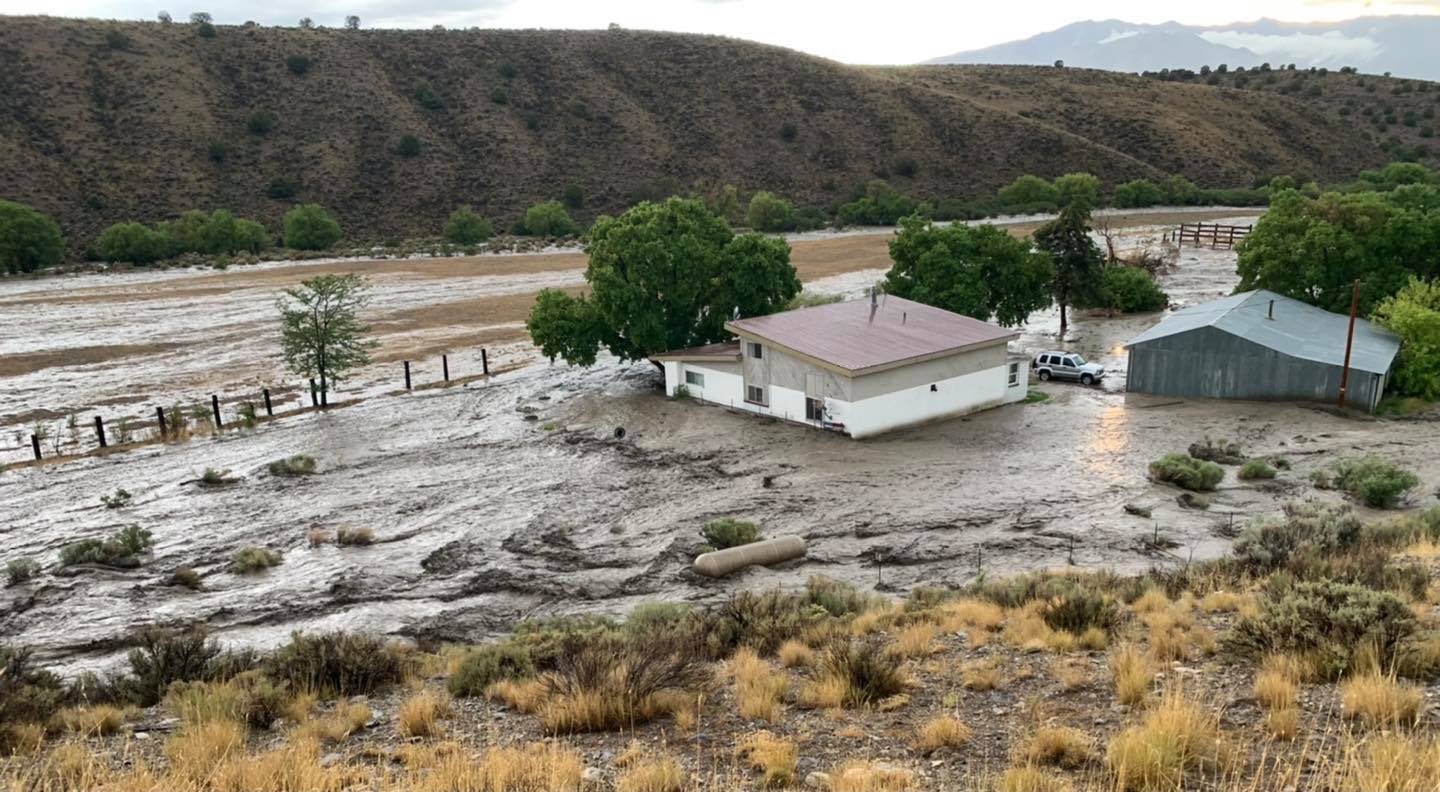 Floodwater rushes past homes near Soldier Canyon in Stockton on Sunday, Aug. 1. Stockton Police Chief Travis Romney said a woman was rescued after water flooded her home.