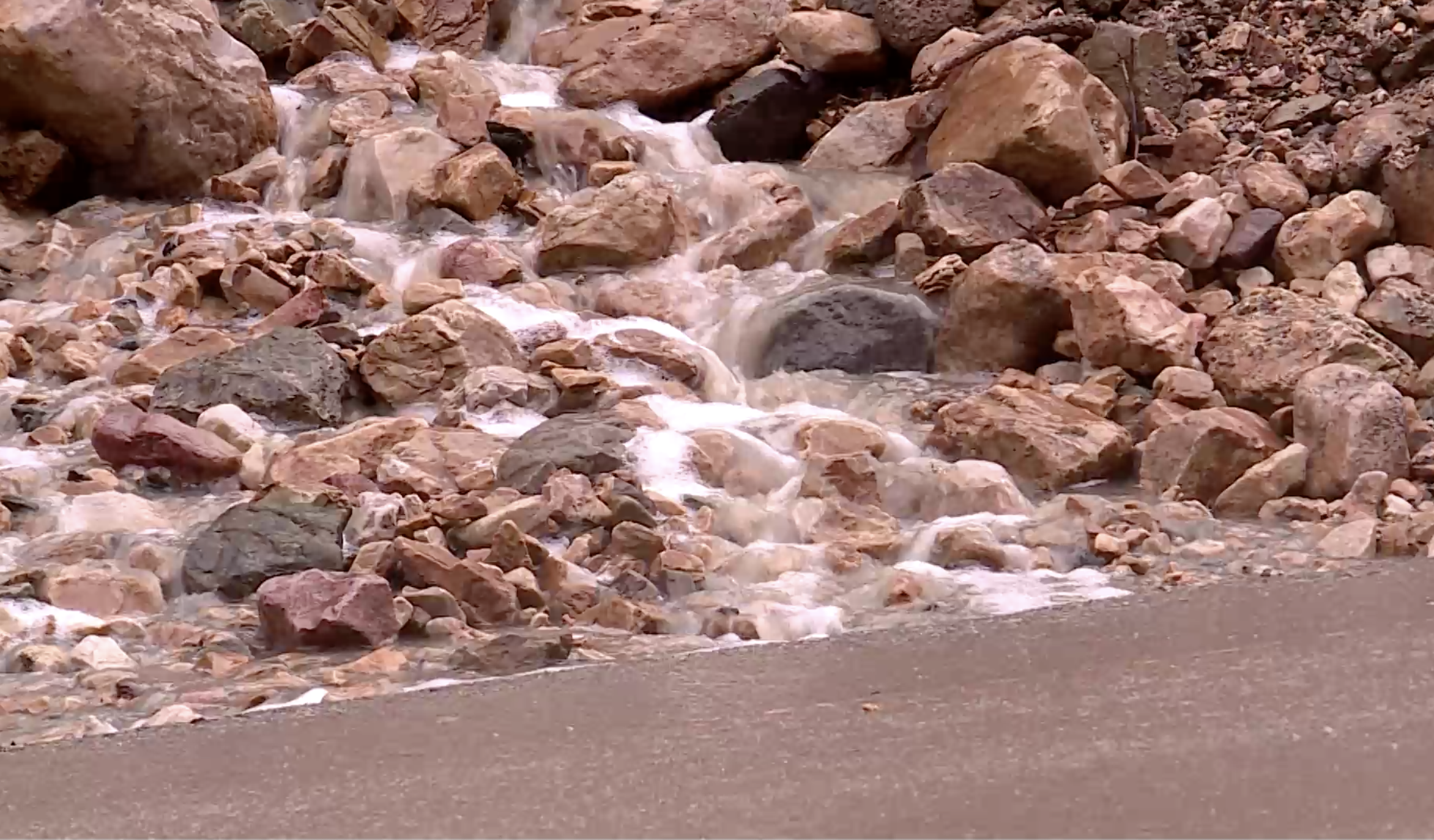 Water cascades down a debris pile at Big Cottonwood Canyon on Monday, Aug. 2. The pile was pushed to the side of the road following a rockslide in the canyon Sunday evening.