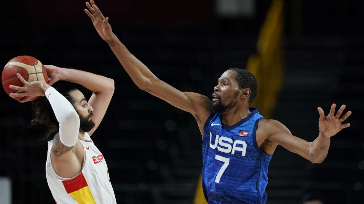 United States' Kevin Durant (7), right, tries to block Spain's Ricky Rubio (9), left, during men's basketball quarterfinal game at the 2020 Summer Olympics, Tuesday, Aug. 3, 2021, in Saitama, Japan.