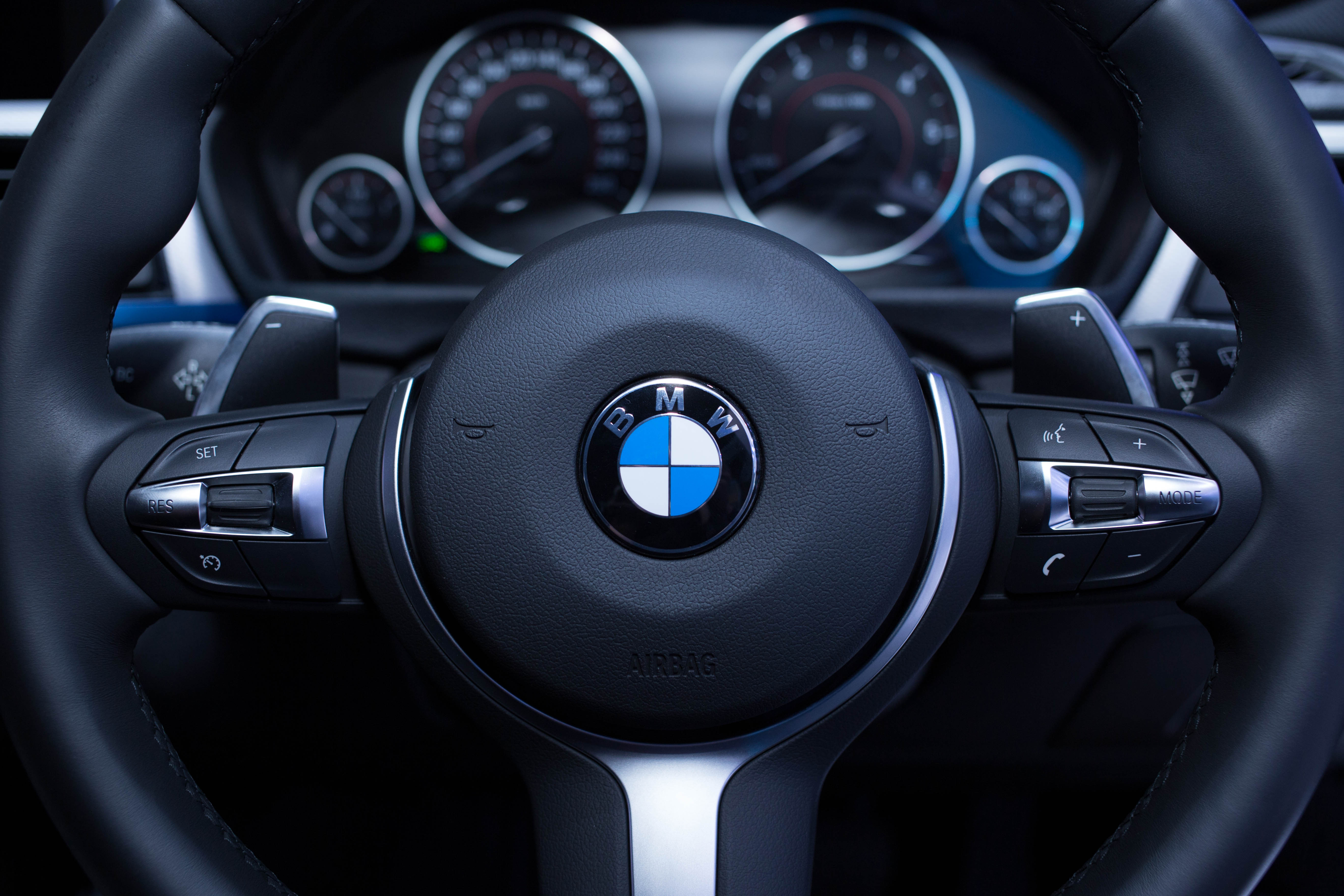 The steering wheel of a BMW. BMW and Stellantis became the latest major carmakers to warn on Tuesday that the global semiconductor chip shortage will drag on throughout 2021 and beyond.