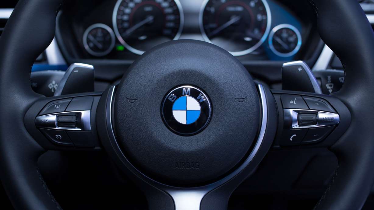 The steering wheel of a BMW. BMW and Stellantis became the latest major carmakers to warn on Tuesday that the global semiconductor chip shortage will drag on throughout 2021 and beyond.