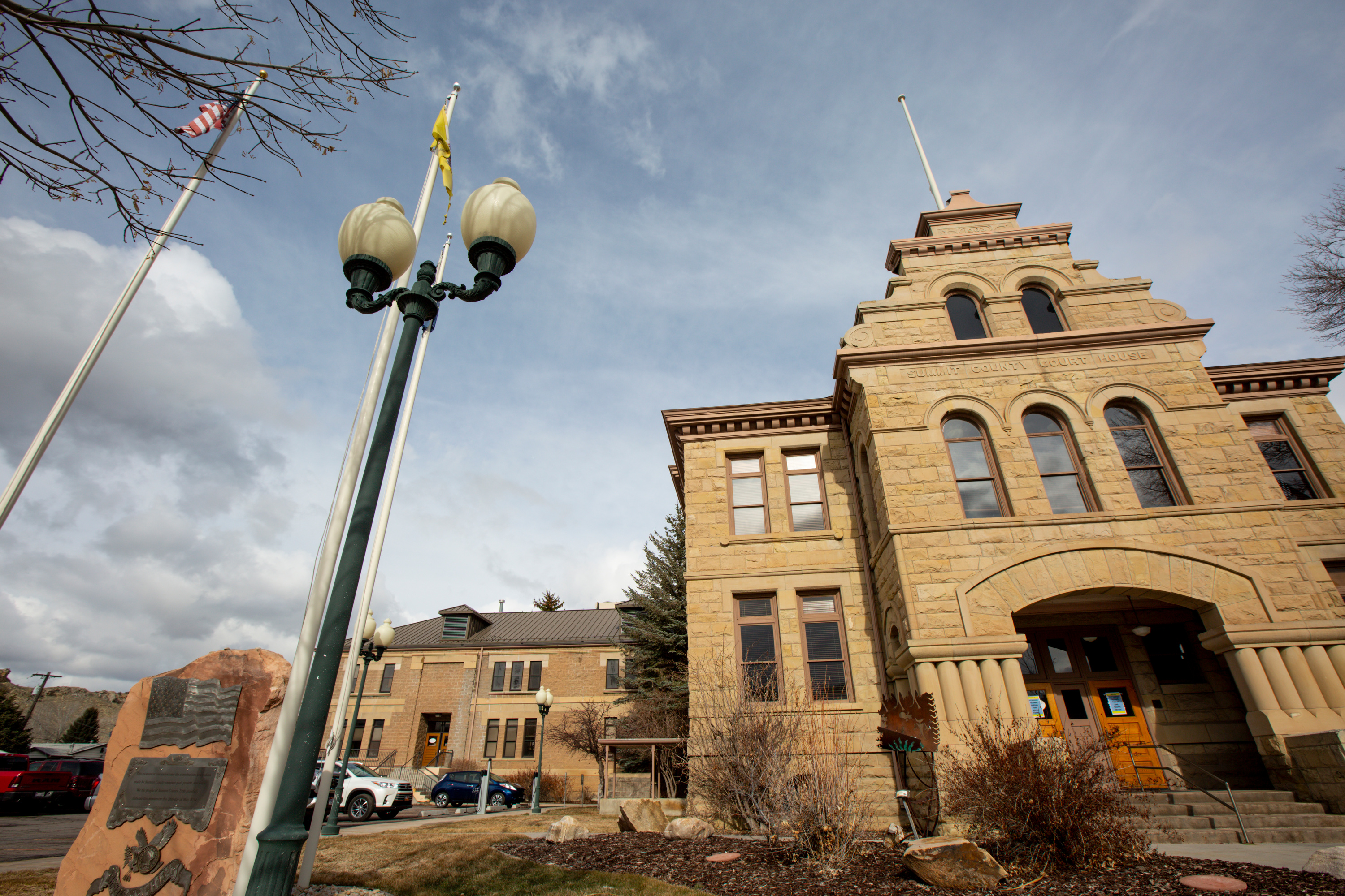 A Coalville man was charged Tuesday with threatening to burn his house down with his wife's two dogs inside.