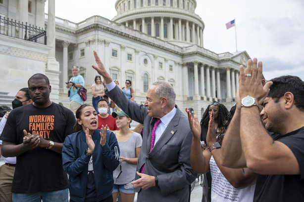 From left, Rep. Mondaire Jones, D-N.Y., Rep. Alexandria Ocasio-Cortez, D-N.Y. and Senate Majority Leader Chuck Schumer, D-N.Y., celebrate the announcement that the Biden administration will enact a targeted nationwide eviction moratorium outside of Capitol Hill in Washington on Tuesday, Aug. 3, 2021.