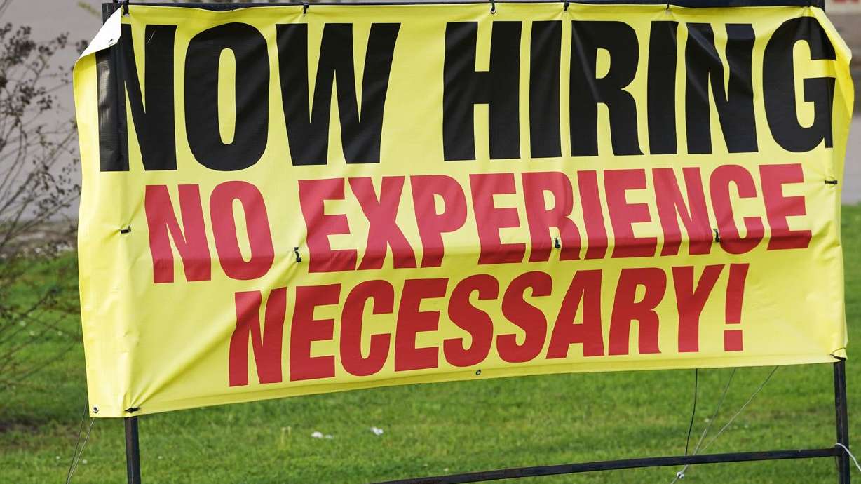 A roadside banner beckons potential employees outside a
company in Hattiesburg, Miss., on March 27, 2021. Utah’s Gov. Cox
hopes that by nixing COVID-19 unemployment benefits, unemployed
Utahns will return to work.