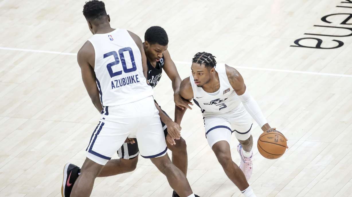 Utah Jazz center Udoka Azubuike sets a pick so guard Trent Forrest can get past San Antonio Spurs guard Justin Turner during an NBA Summer League game at Vivint Smart Home Arena in Salt Lake City on Tuesday, Aug. 3, 2021.