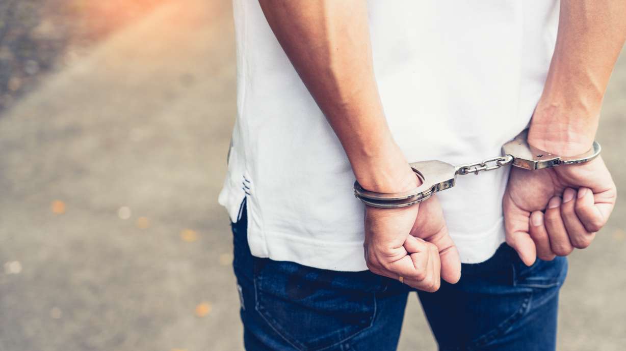 A man who was apparently upset that he couldn't drive past a barricade blocking a road was arrested Tuesday after police say he pointed a gun at a construction worker's head.