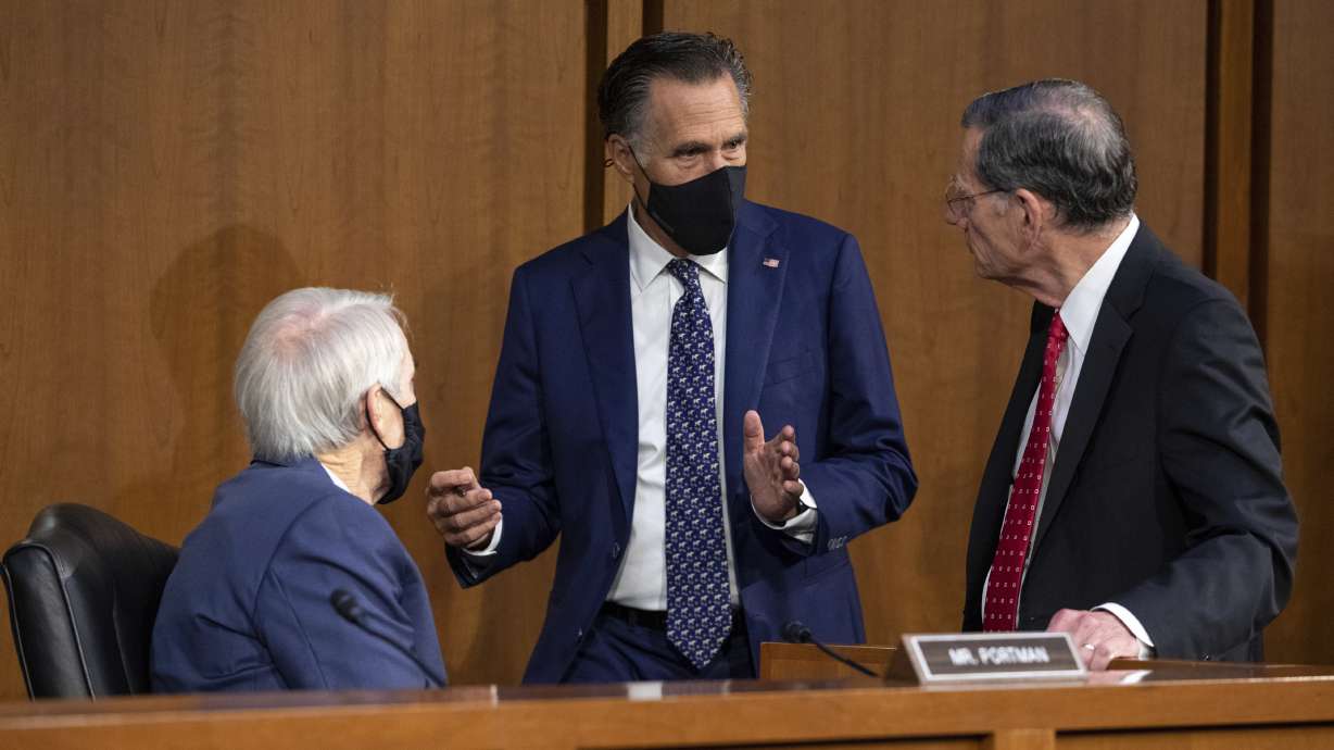 From left, Sen. Rob Portman, R-Ohio, Sen. Mitt Romney, R-Utah, and Sen. John Barrasso, R-Wyo., speak before a meeting on Capitol Hill Wednesday.