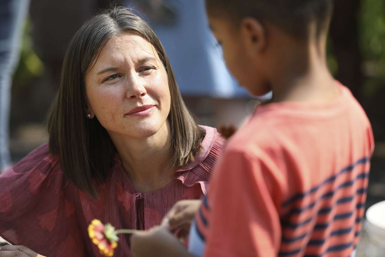 Salt Lake City Mayor Erin Mendenhall speaks with Idris Ahmad, 5, at a new community garden at Richmond Park in Salt Lake City on Wednesday.