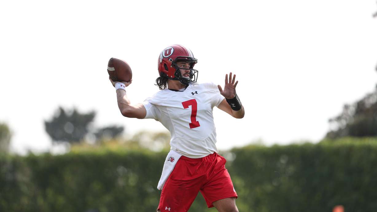 Cam Rising (7) throws a pass during the first day of fall camp at the University of Utah on Wednesday.
