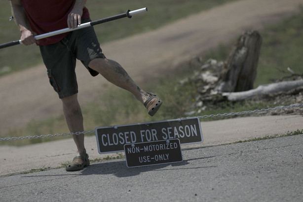 A kayaker walks over the chain at the Rock Cliff boat
ramp at Jordanelle Reservoir near Kamas on Wednesday, Aug. 4, 2021.
The Rock Cliff boat ramp remains out of the water but smaller,
nonmotorized vessels may be launched off the old road at the bottom
of the ramp.