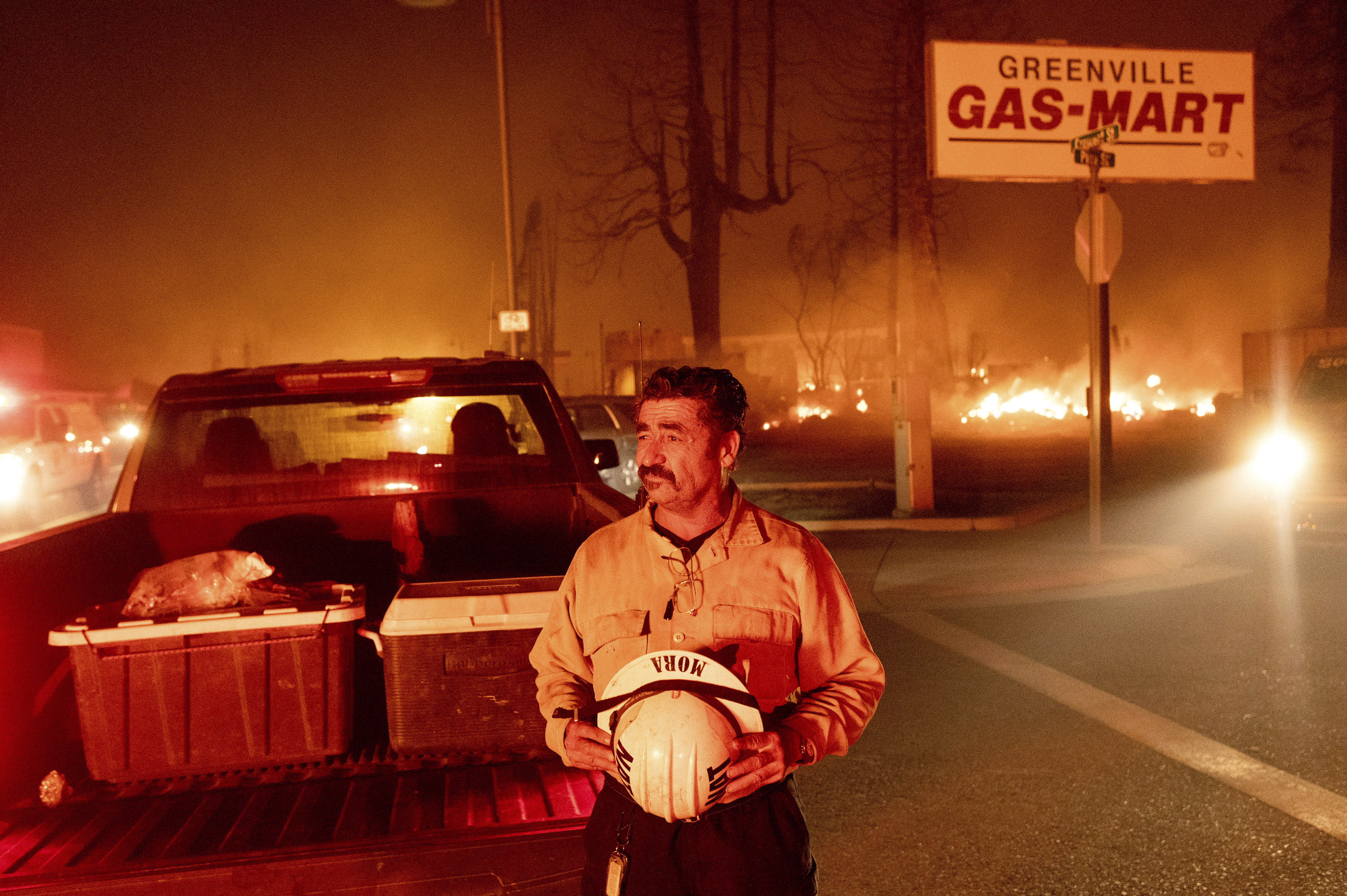 Battalion Chief Sergio Mora watches as the Dixie Fire tears through the Greenville community of Plumas County, Calif., on Wednesday. The fire leveled multiple historic buildings and dozens of homes in central Greenville.