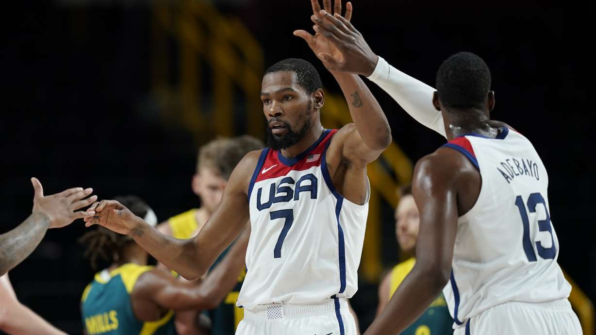 United States's Kevin Durant (7) celebrates with teammates after scoring during men's basketball semifinal game against Australia at the 2020 Summer Olympics, Thursday, Aug. 5, 2021, in Saitama, Japan.