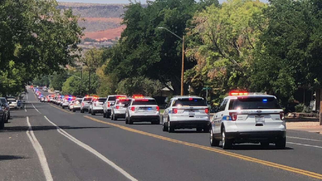 Police patrol units stretch along east 300 South in St. George Wednesday during a funeral procession for fallen St. George police officer Adam Ashworth.