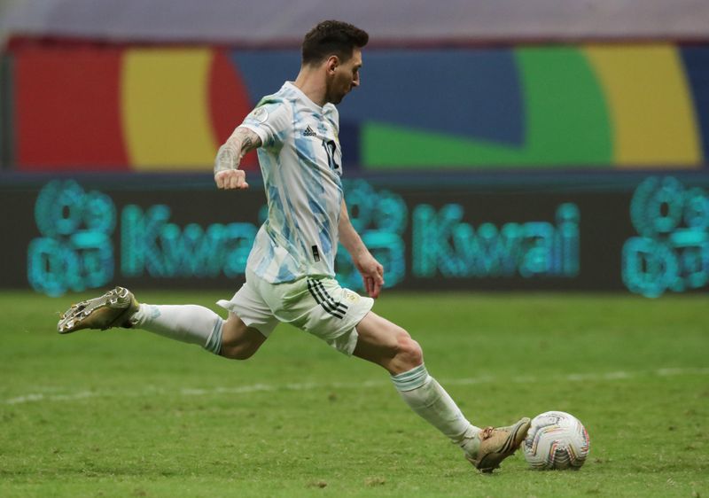 Argentina's Lionel Messi scores a penalty during a penalty shootout.