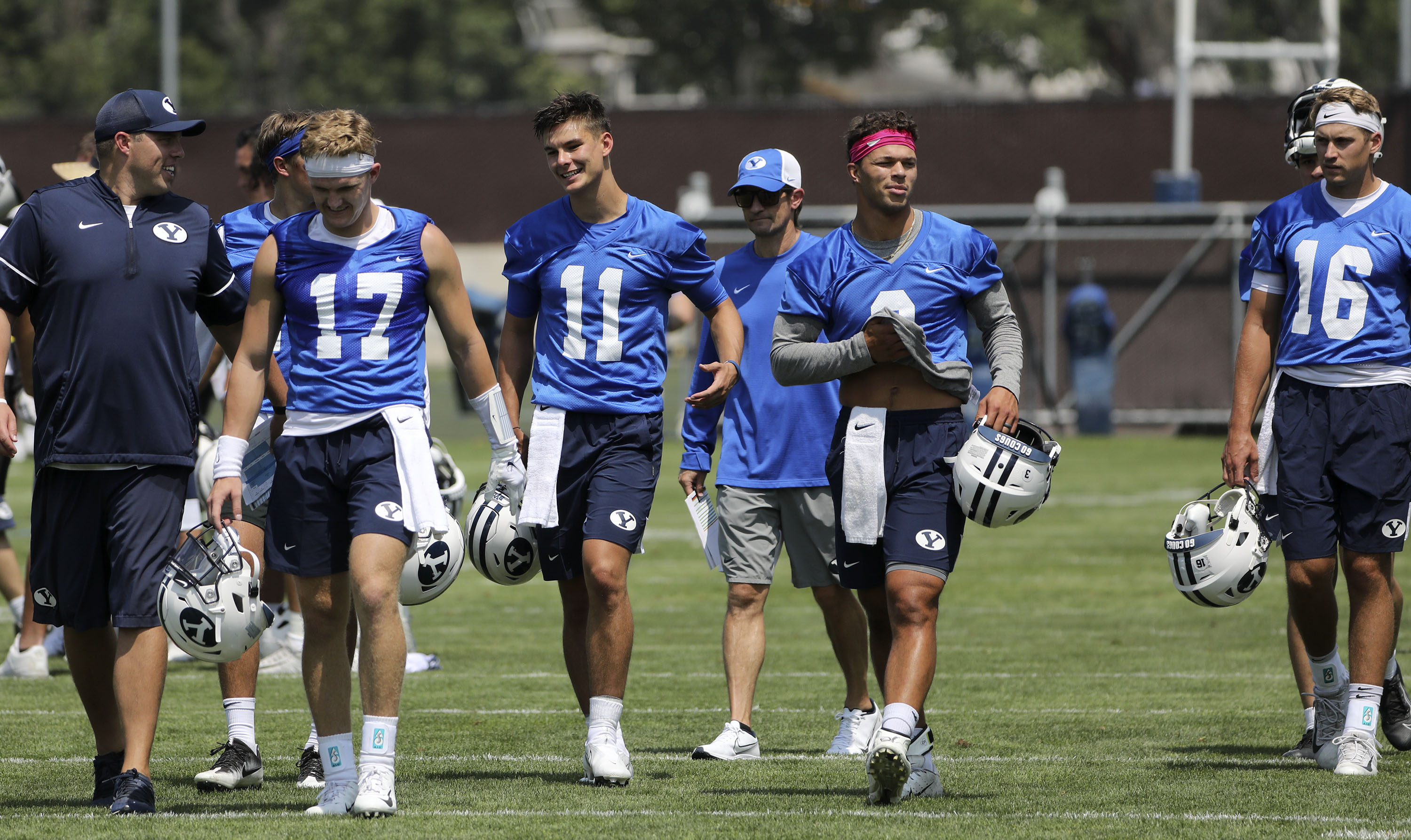 BYU’s quarterbacks Jacob Conover (17), Cade Fennegan (11), Jaren Hall (3) and Baylor Romney (16) leave practice in Provo on Thursday, Aug. 5, 2021.