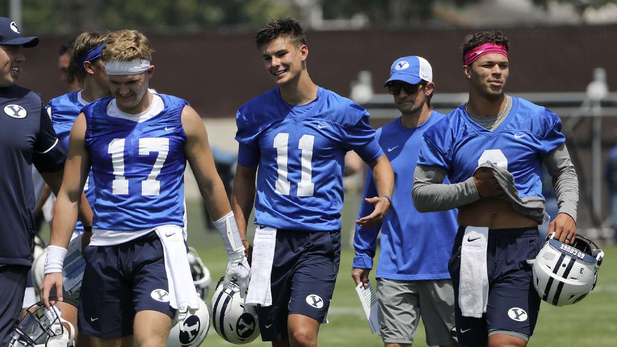 BYU’s quarterbacks Jacob Conover (17), Cade Fennegan (11), Jaren Hall (3) and Baylor Romney (16) leave practice in Provo on Thursday, Aug. 5, 2021.