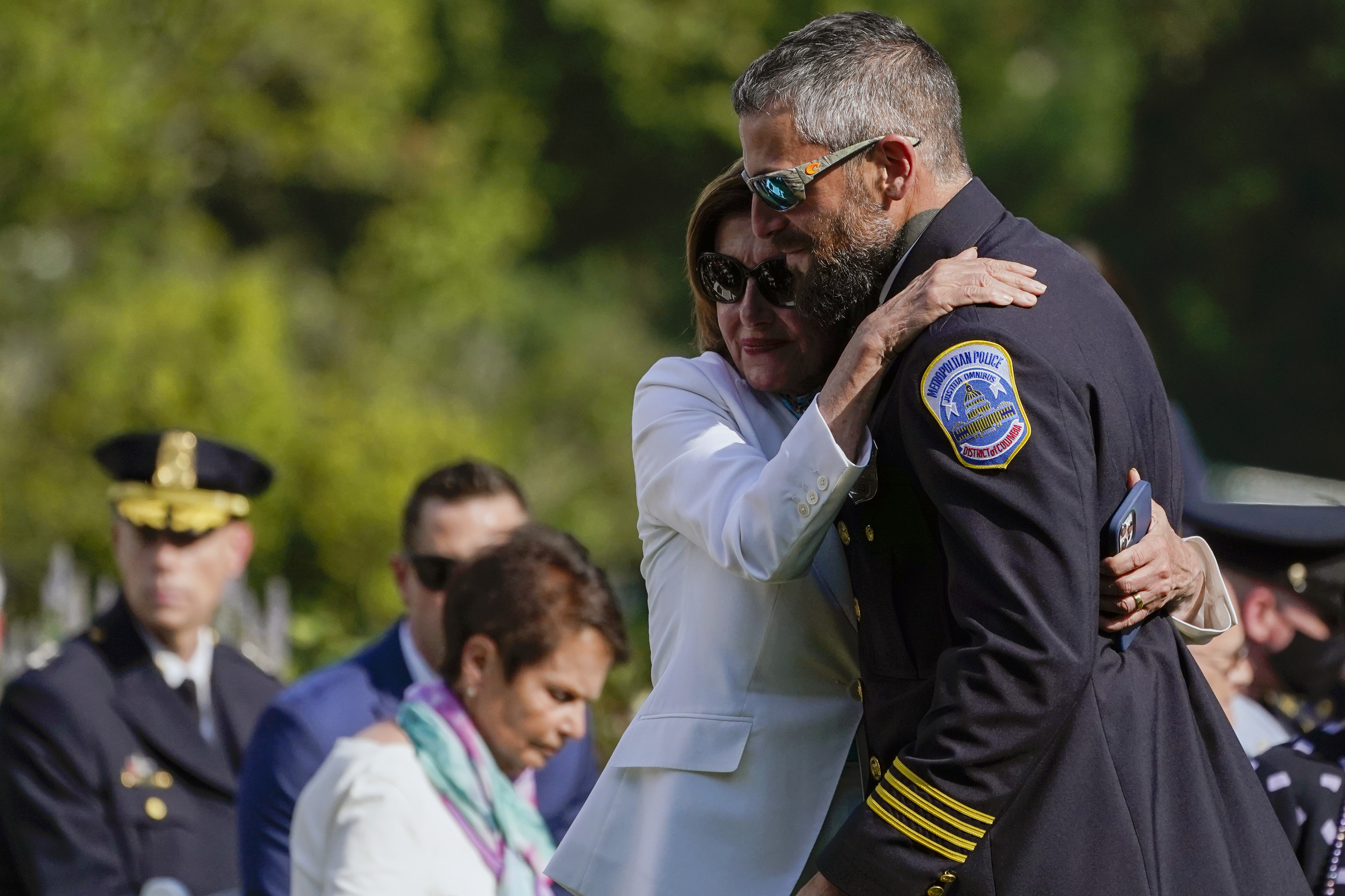 House Speaker Nancy Pelosi of Calif., hugs Washington Metropolitan Police Department officer Michael Fanone as they arrive for a bill signing that awards Congressional gold medals to law enforcement officers that protected members on Congress at the Capitol during the Jan. 6 riots, in the Rose Garden of the White House on Thursday.