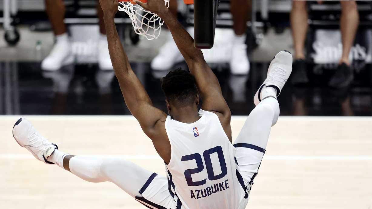 Utah Jazz' Udoka Azubuike hammers down a dunk after receiving a pass from white teammate Devonte Green as they play in summer league action at Vivint Smart Home Arena in Salt Lake City on Wednesday.