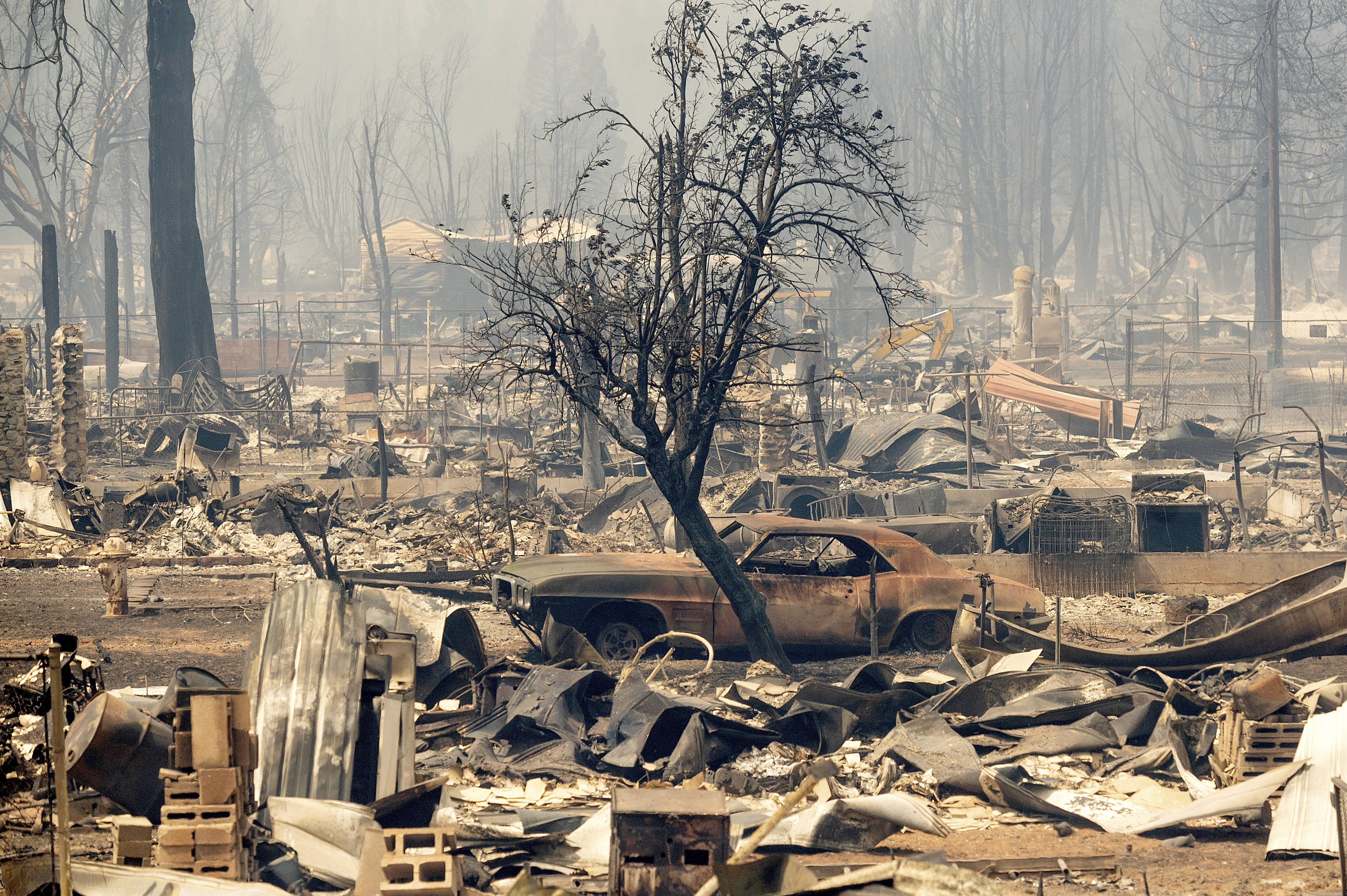 Homes and cars destroyed by the Dixie Fire line central Greenville on Thursday, in Plumas County, Calif.