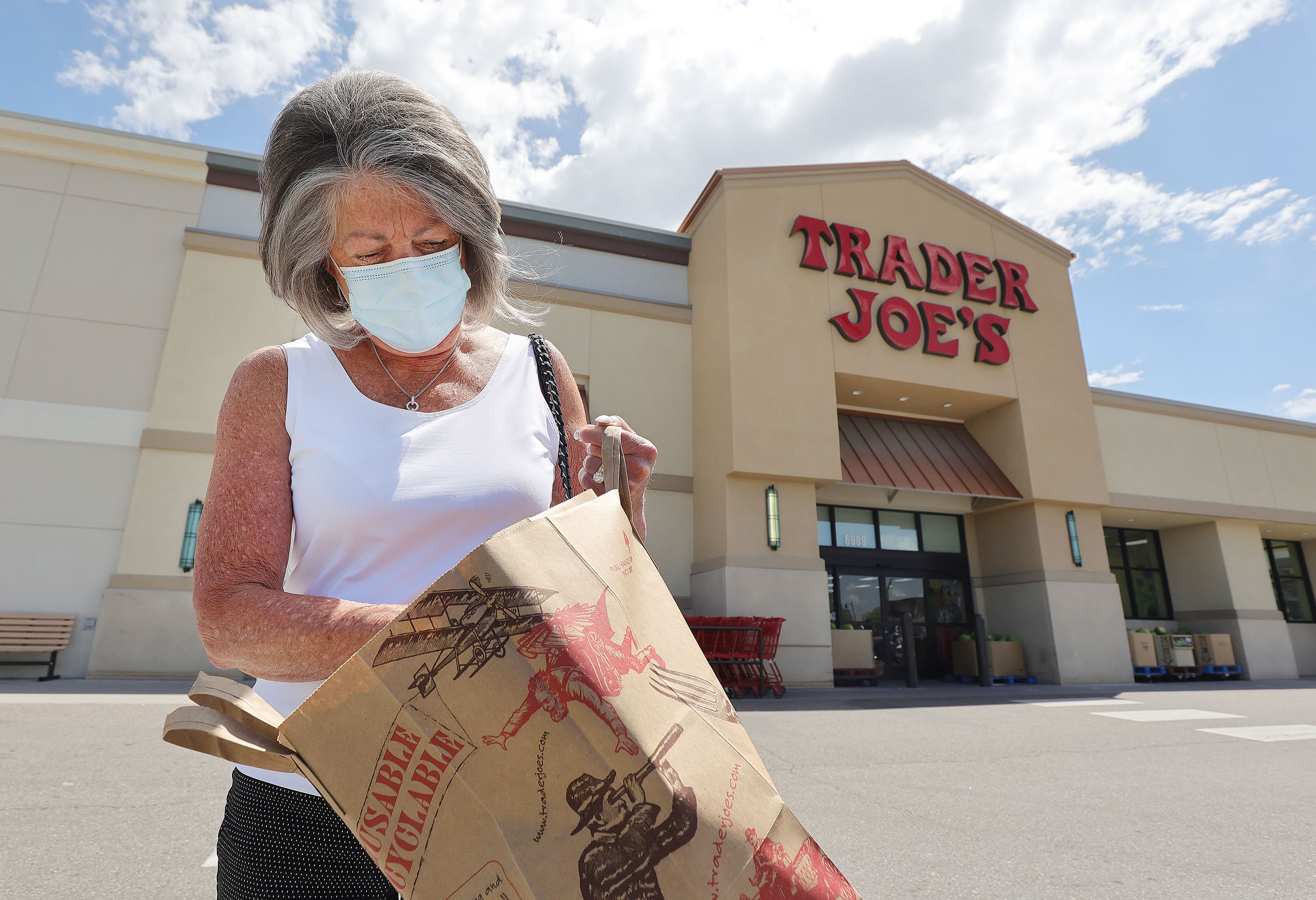 Susan Holding Rosetta leaves Trader Joe's in Cottonwood Heights after shopping on Friday, May 14. Trader Joe's is one of the first stores to drop the mask requirement for fully vaccinated customers.