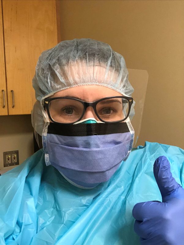 Nichole Atherton, an intensive care nurse who has seen a fresh wave of coronavirus disease patients at the hospital where she works, gives a thumbs-up in Ocean Springs, Mississippi, U.S.