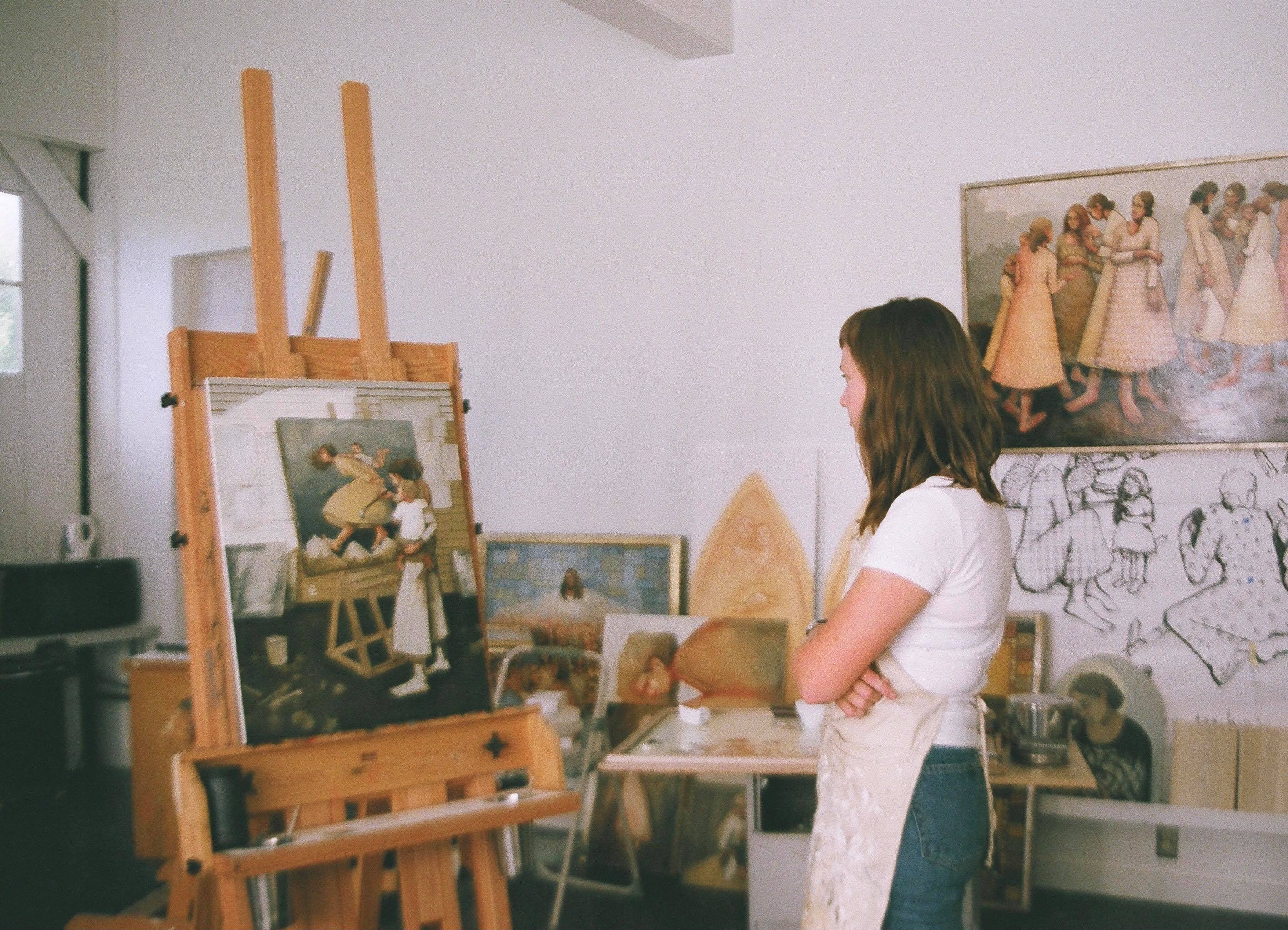 Utah artist Caitlin Connolly looks at one of her paintings. Connolly is one of many local women to join Meghan Markle's 40x40 campaign to help women back into the workforce.