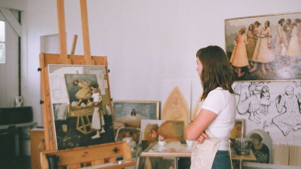 Utah artist Caitlin Connolly looks at one of her paintings. Connolly is one of many local women to join Meghan Markle's 40x40 campaign to help women back into the workforce.