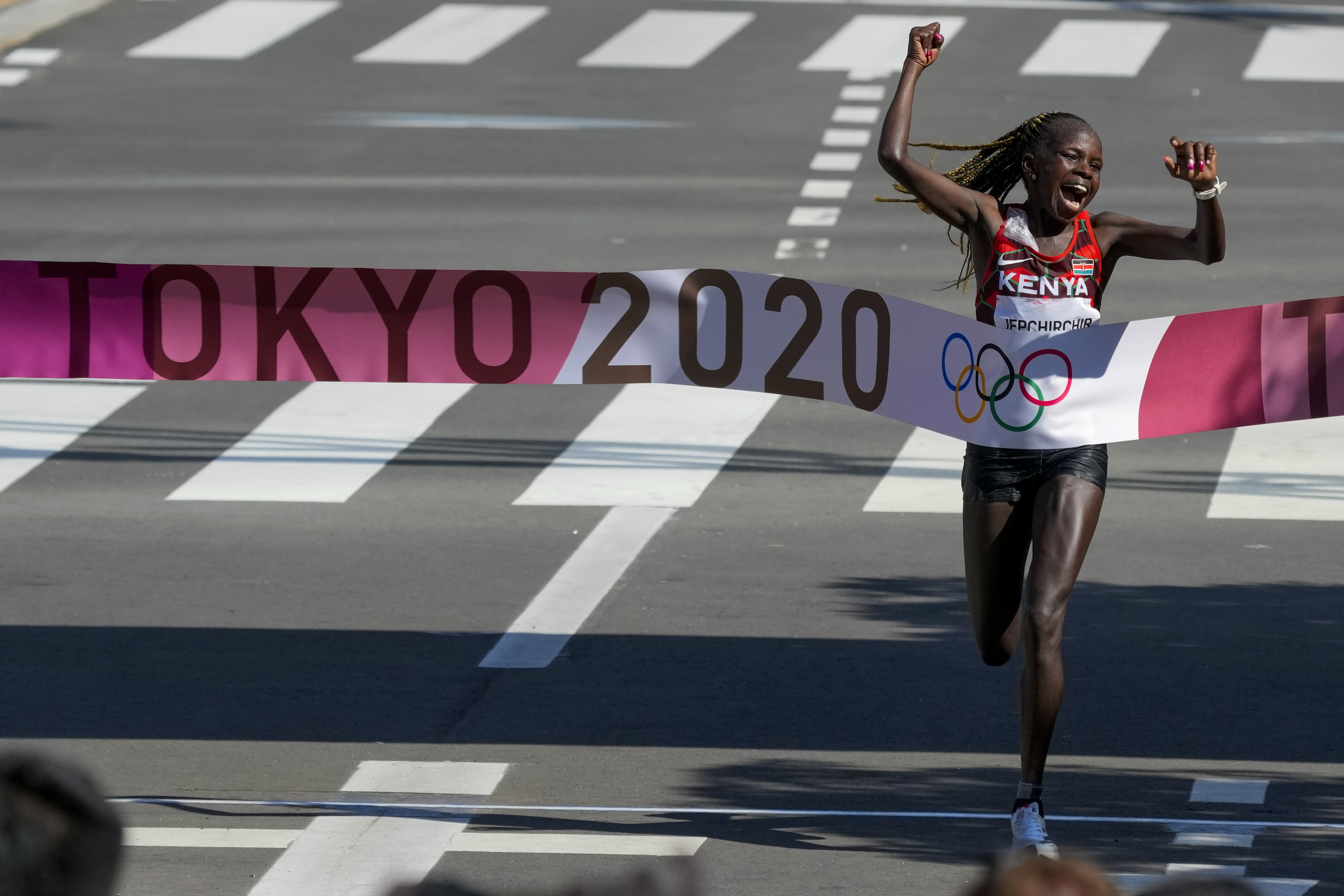 Peres Jepchirchir, of Kenya, celebrates as she crosses the finish line to win the women's marathon at the 2020 Summer Olympics, Saturday, Aug. 7, 2021, in Sapporo, Japan 