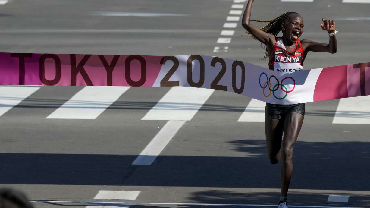 Peres Jepchirchir, of Kenya, celebrates as she crosses the finish line to win the women's marathon at the 2020 Summer Olympics, Saturday, Aug. 7, 2021, in Sapporo, Japan