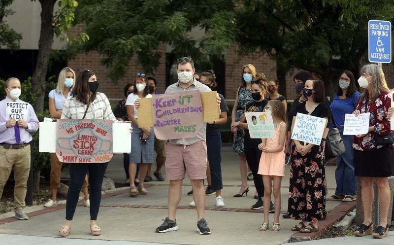 Parents, teachers and students rally in support of school mask mandates outside of the Utah State Board of Education office in Salt Lake City on Friday.