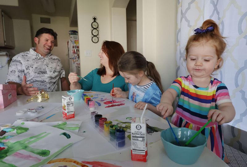 Andrew and Ashley Munk watch their children Mara, 5,
and Ellie, 2, paint at their home in Draper on Thursday. Ashley Munk spoke during the "Families First: What the Build
Back Better Agenda Means for People of Faith” virtual meeting that
the White House held on Aug. 4 to tout President Joe Biden’s Build
Back Better agenda.