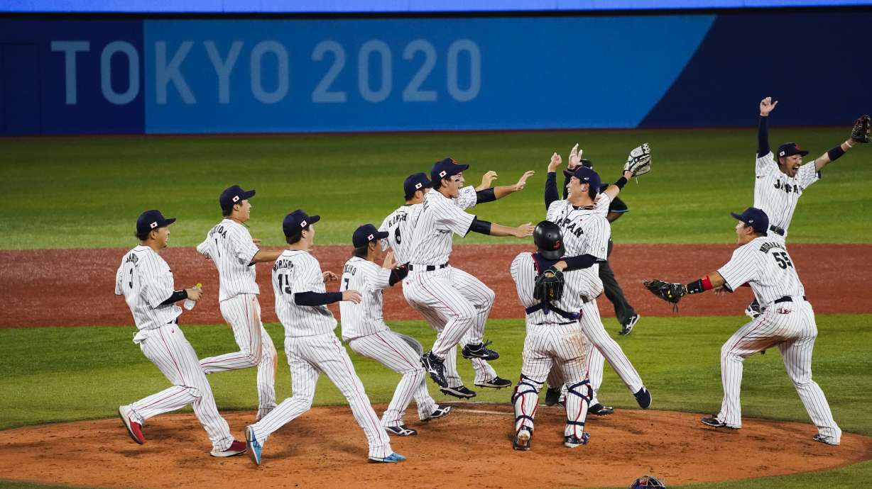 Team Japan celebrate after the gold medal baseball game against the United States at the 2020 Summer Olympics, Saturday, Aug. 7, 2021, in Yokohama, Japan. Japan won 2-0.
