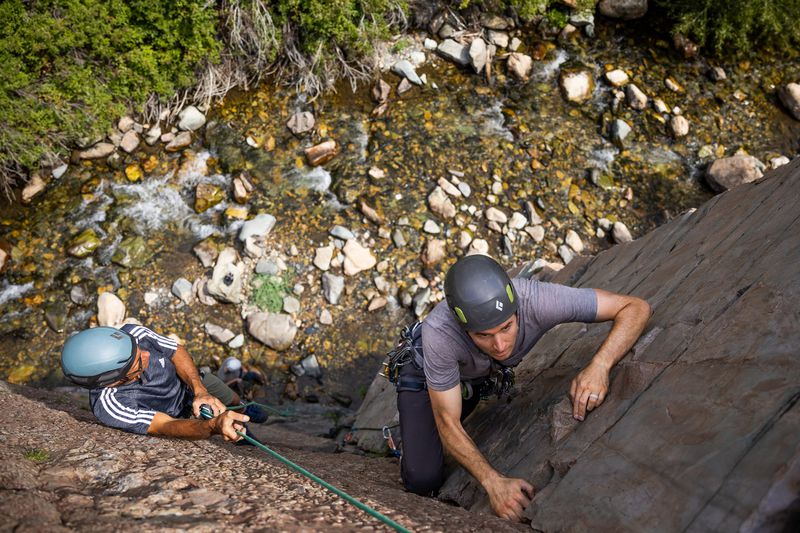 Quino Gonzalez, a guide and instructor for Utah
Mountain Adventures, left, supervises while Steve Mullalley climbs
during a trad climbing clinic in Big Cottonwood Canyon on Saturday,
July 31, 2021.