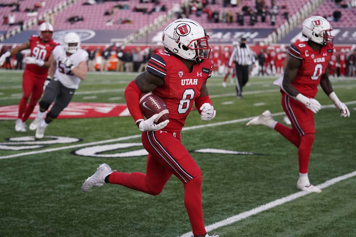 Utah cornerback Clark Phillips III (8) returns an interception for a touchdown against Washington State during the second half of an NCAA college football game Saturday, Dec. 19, 2020, in Salt Lake City.