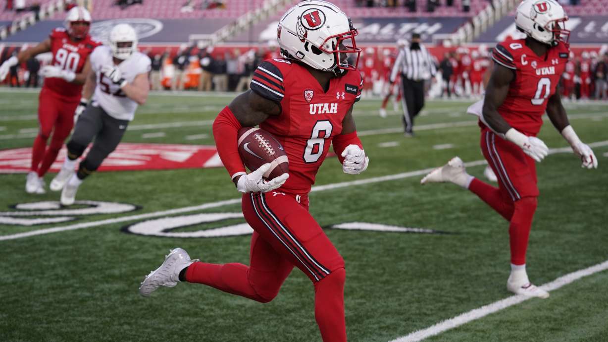 Utah cornerback Clark Phillips III (8) returns an interception for a touchdown against Washington State during the second half of an NCAA college football game Saturday, Dec. 19, 2020, in Salt Lake City.