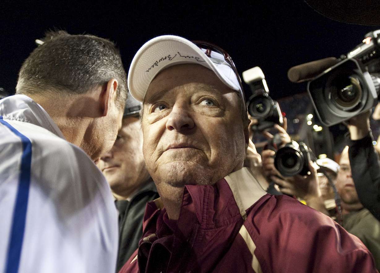 In this Saturday, Nov. 28, 2009 file photo, Florida State head football coach Bobby Bowden wears a dejected expression as he turns to leave Florida coach Urban Meyer after congratulating Meyer following Florida's 37-10 win over Florida during an NCAA football game in Gainesville ,Fla. The Hall of Fame college football coach Bobby Bowden has died after a battle with pancreatic cancer. Exuding charm and wit, Bowden led Florida State to two national championships and a record of 315-98-4 during his 34 seasons with the Seminoles. In all, Bowden had 377 wins during his 40 years in major college coaching. He was 91 years old.