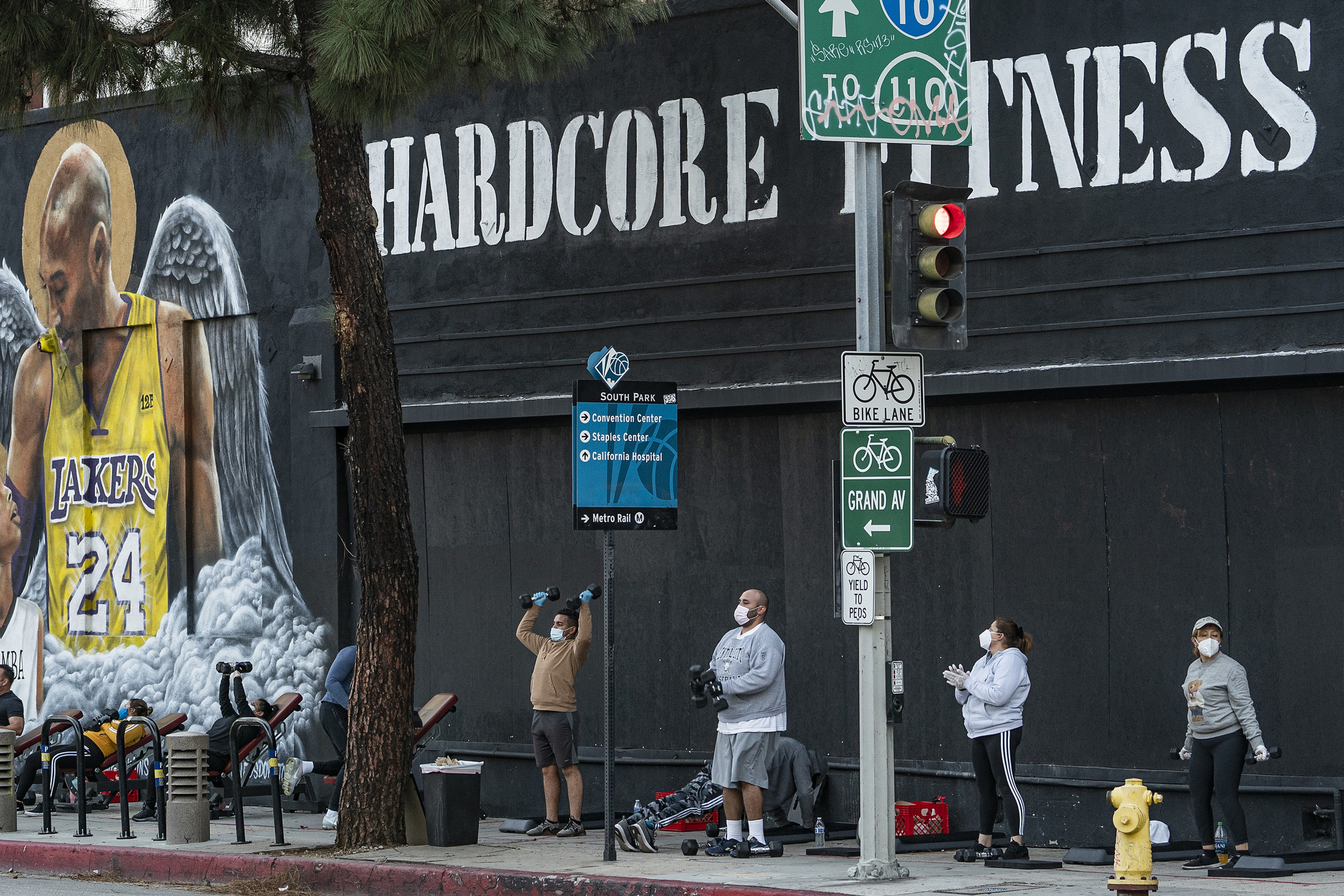 People wear masks as they work out outside the Hardcore Fitness gym, due to COVID-19 restrictions in downtown Los Angeles in January, 2021. The pandemic has changed how the fitness industry evaluates itself.