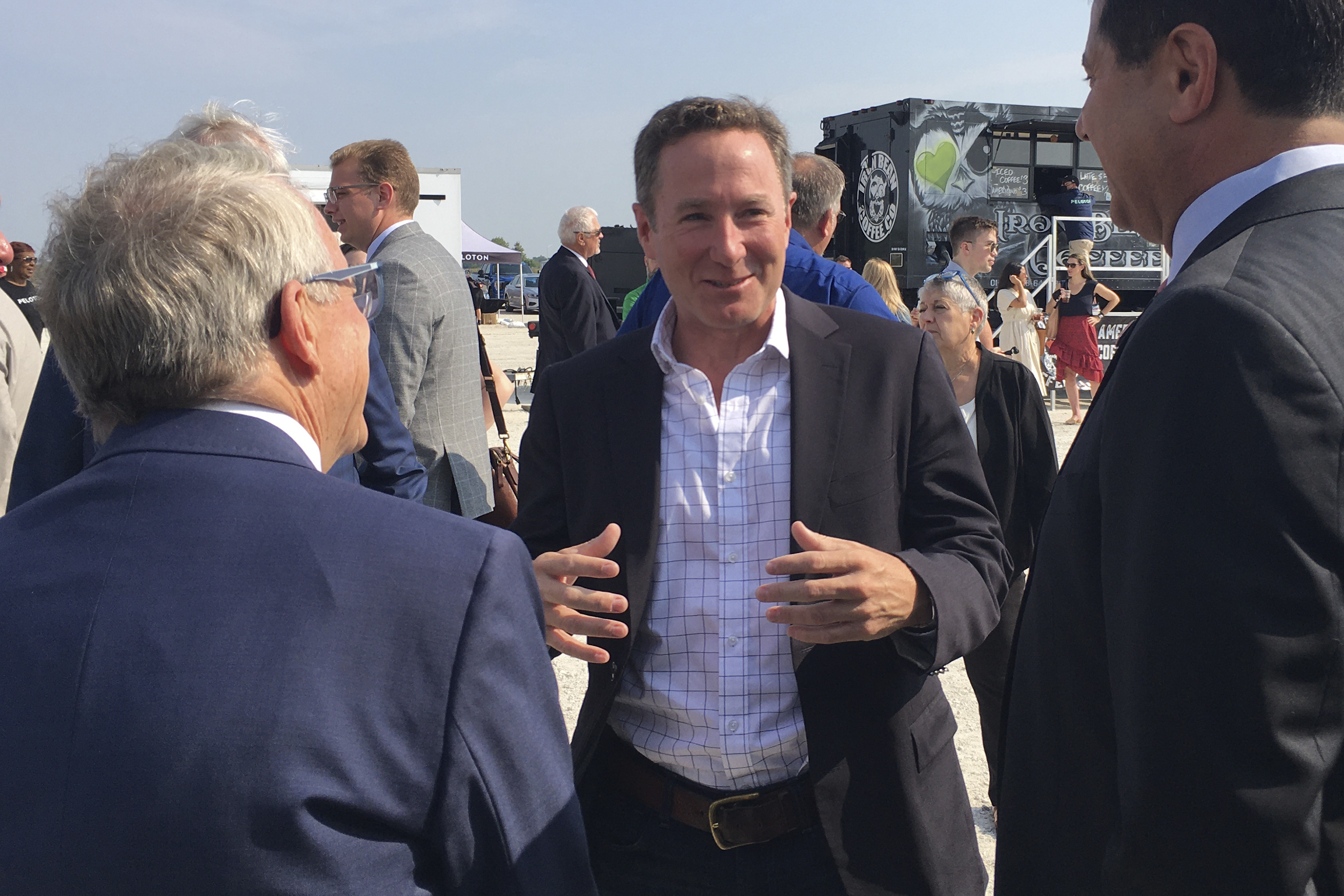 Peloton CEO John Foley, center, speaks with those gathered for the groundbreaking for the company's first U.S. factory, including Ohio Gov. Mike DeWine, left, Monday, Aug. 9, 2021, in Luckey, Ohio. Interactive fitness equipment maker Peloton is betting the workout-from-home trend is here to stay and is breaking ground on its first U.S. factory.