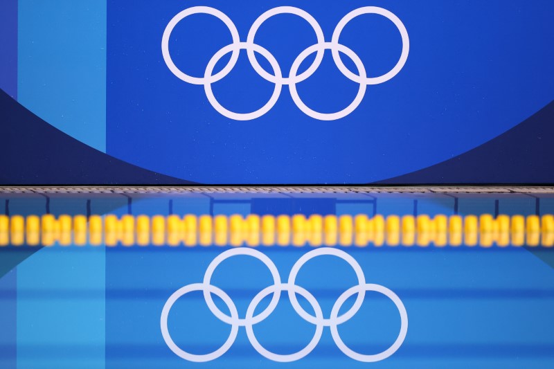 FILE PHOTO: Tokyo 2020 Olympics - Water Polo - Women - Group B - United States v Russian Olympic Committee - Tatsumi Water Polo Centre, Tokyo, Japan - July 30, 2021. The Olympic rings are reflected on the pool.
