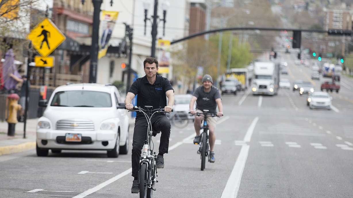 Spencer Moyers and Cory Martin ride electric bicycles in Salt Lake City in April 2017. American Association of State Highway and Transportation Officials recently approved a measure to designate five new routes in Utah where cyclists can ride their bikes long distances using routes that are bike-friendly.