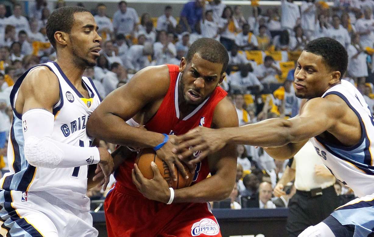 Chris Paul of the Los Angeles Clippers drives between Mike Conley and Rudy Gay of the Memphis Grizzlies in a playoff game in 2012.
