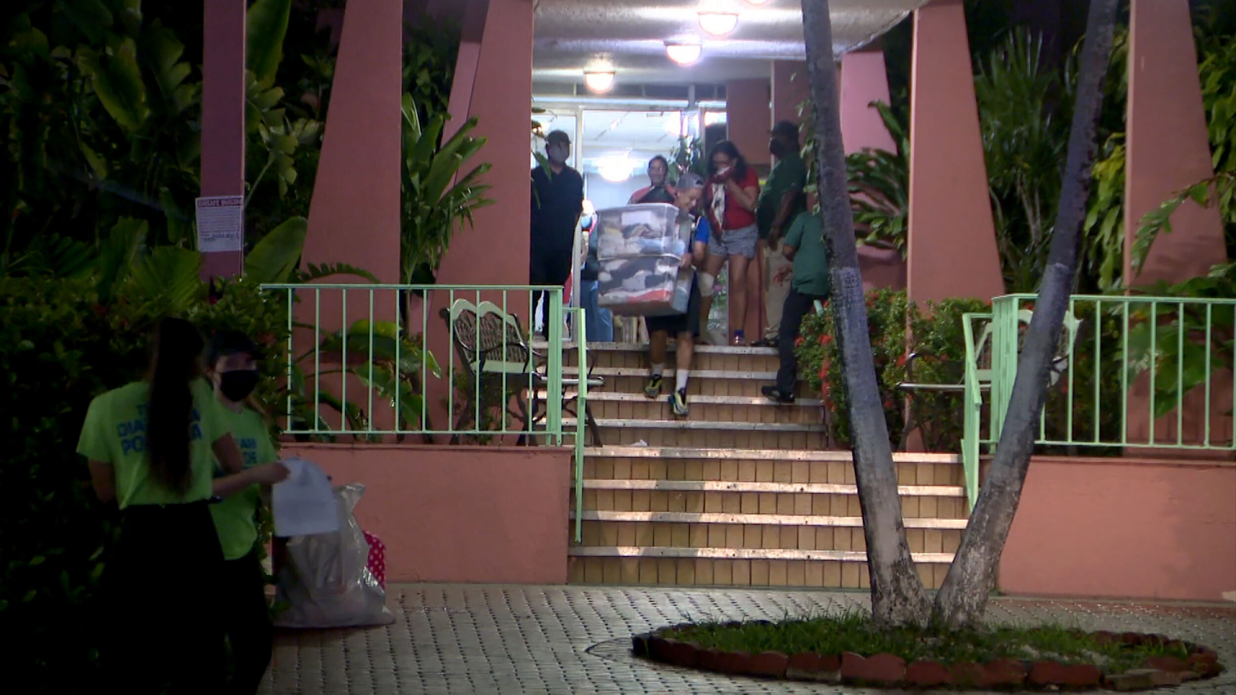 Residents evacuate a building in Miami's Flagami neighborhood. Officials are rushing Tuesday to find temporary housing for residents evacuated from an eight-story residential building that was deemed unsafe, a city spokeswoman said.