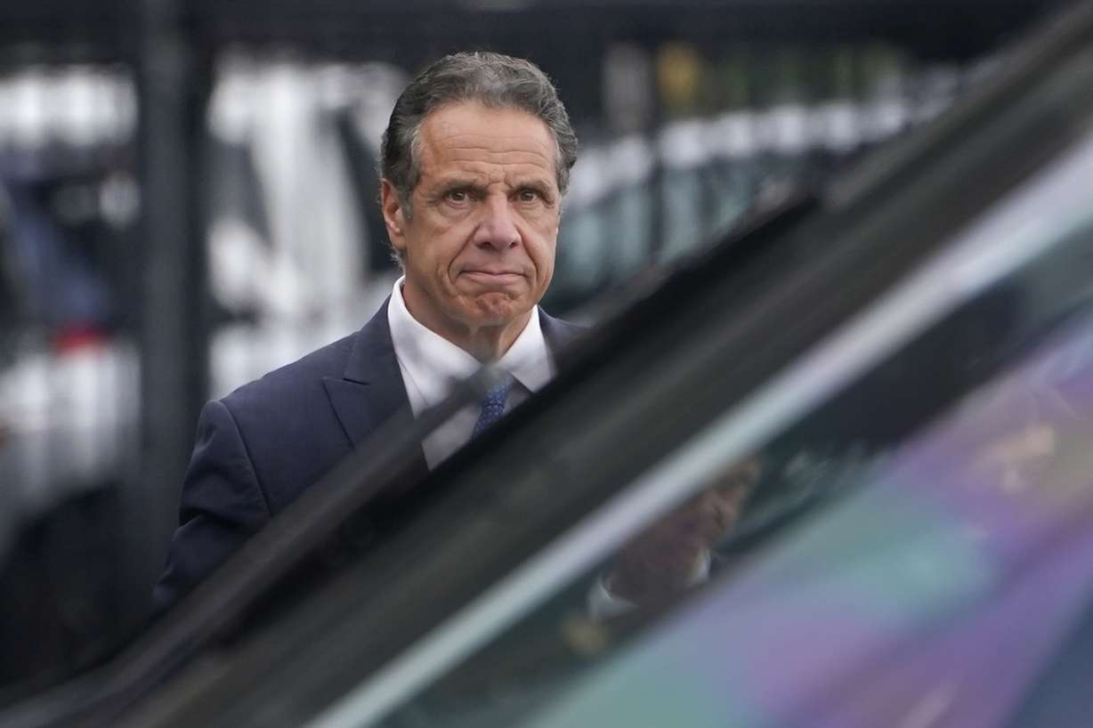 New York Gov. Andrew Cuomo prepares to board a helicopter after announcing his resignation Tuesday in New York. Cuomo says he will resign over a barrage of sexual harassment allegations.