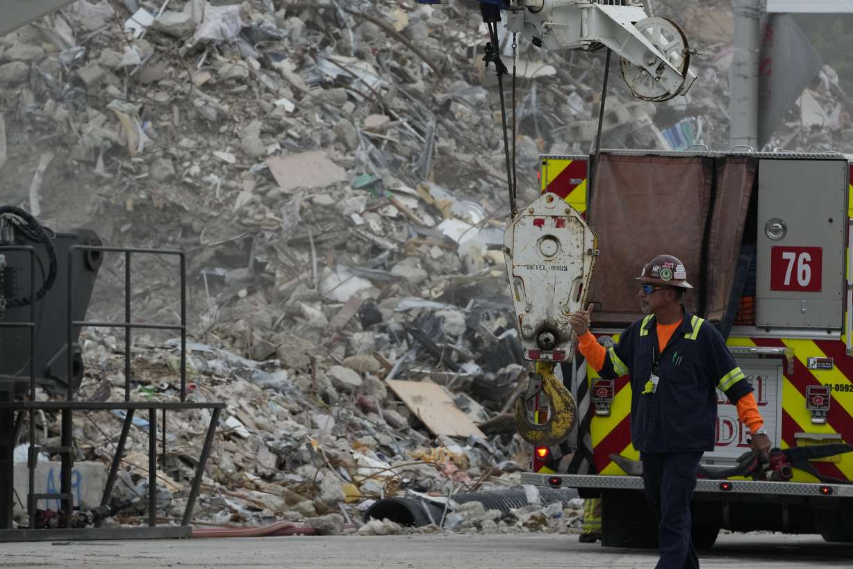Crews work in the rubble of the demolished section of the Champlain Towers South building at the site of the partially collapsed condo building, on July 12, 2021, in Surfside, Florida. Buildings in the Miami area have come under increased scrutiny since June 24, when a huge portion of the condo crumbled to the ground, killing 98 people.